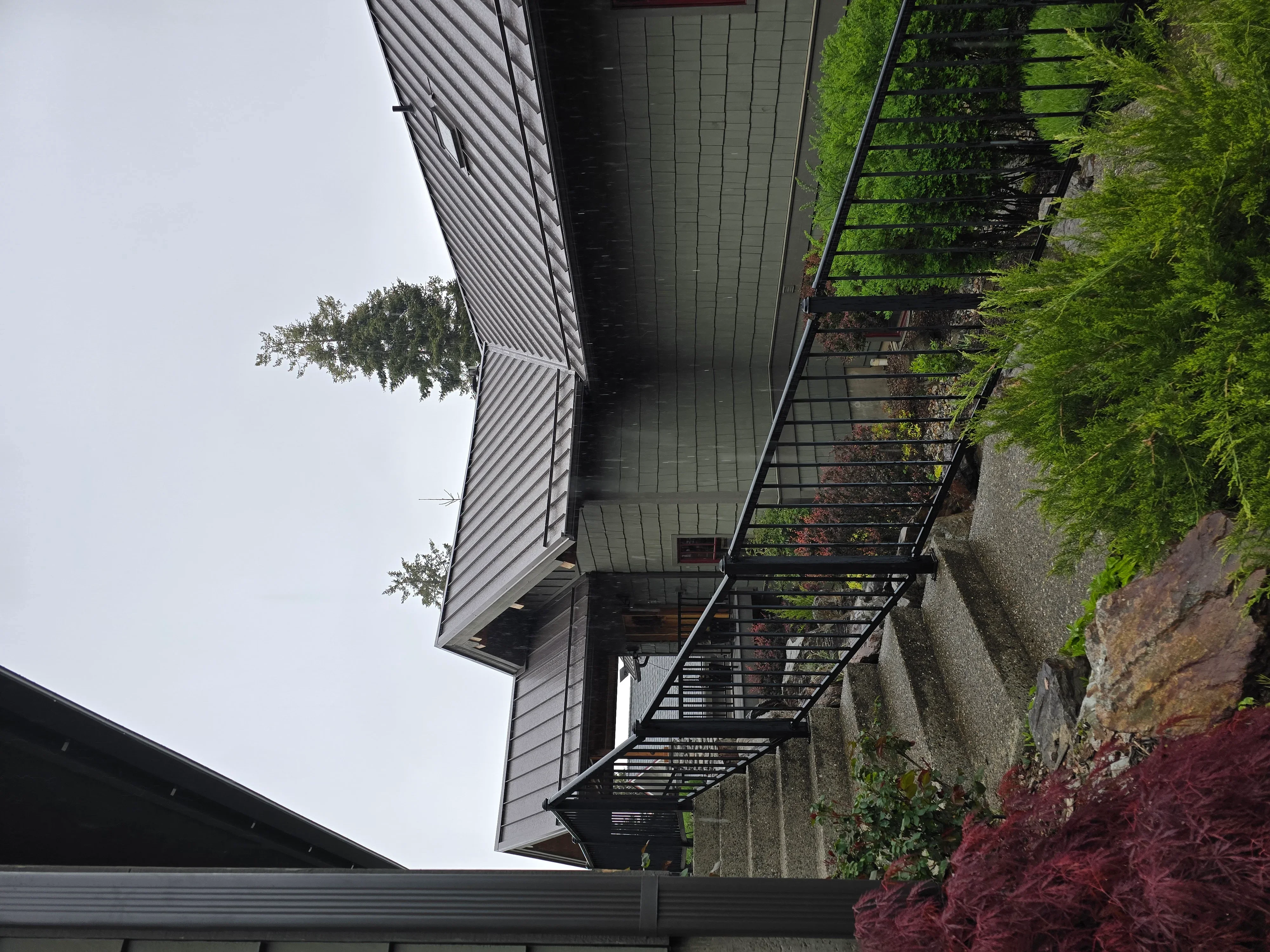 Standing seam metal roof with gray soffit, fascia, and integrated gutters on residential home