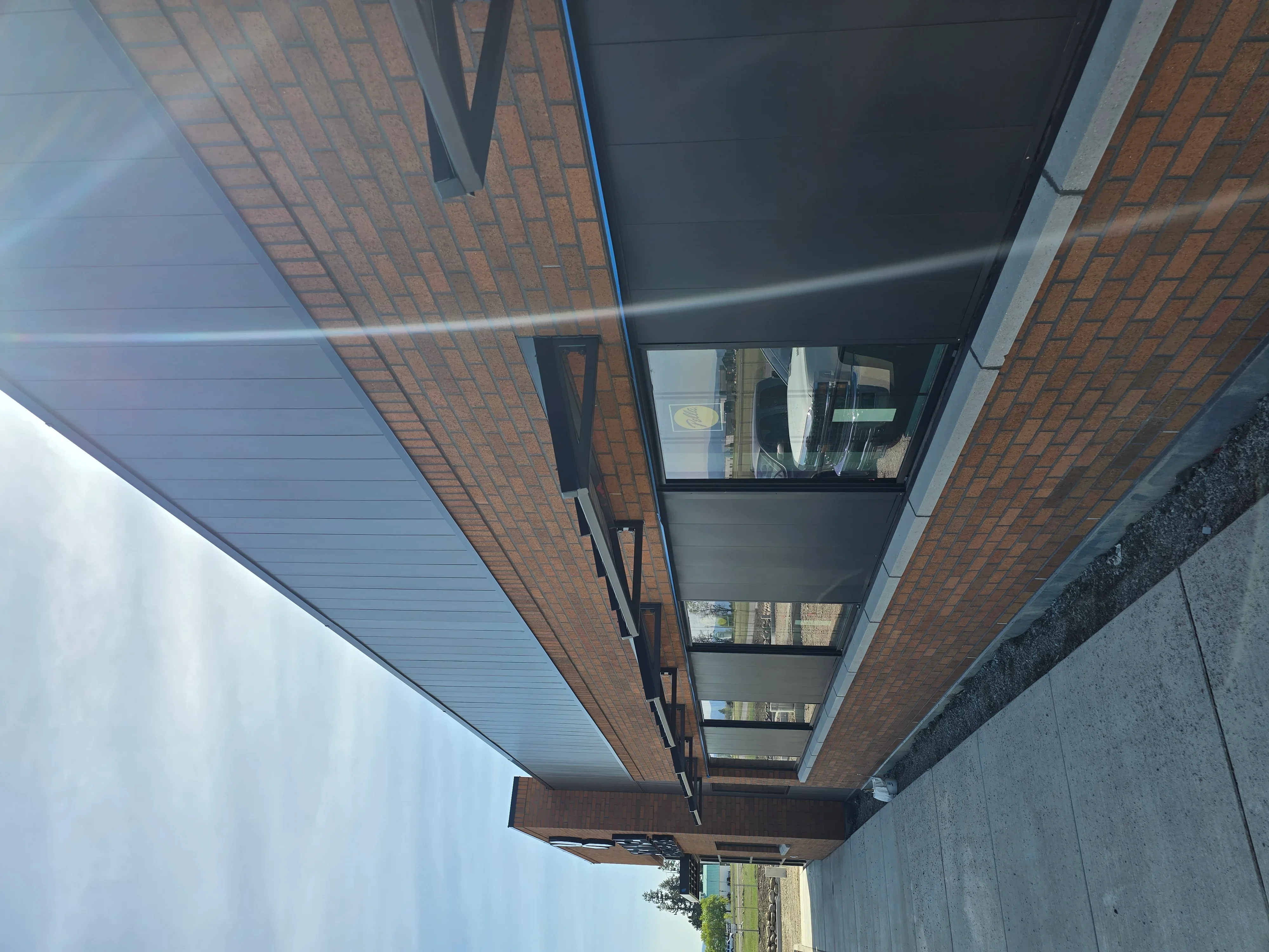 White vinyl soffit and black fascia trim installed on brick home exterior