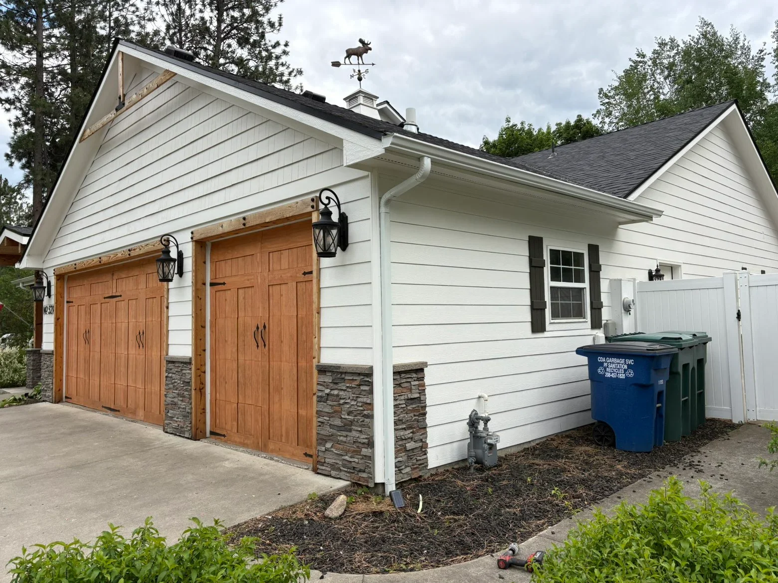 New architectural shingle roof with charcoal gray shingles, white fascia, and cupola with weather vane