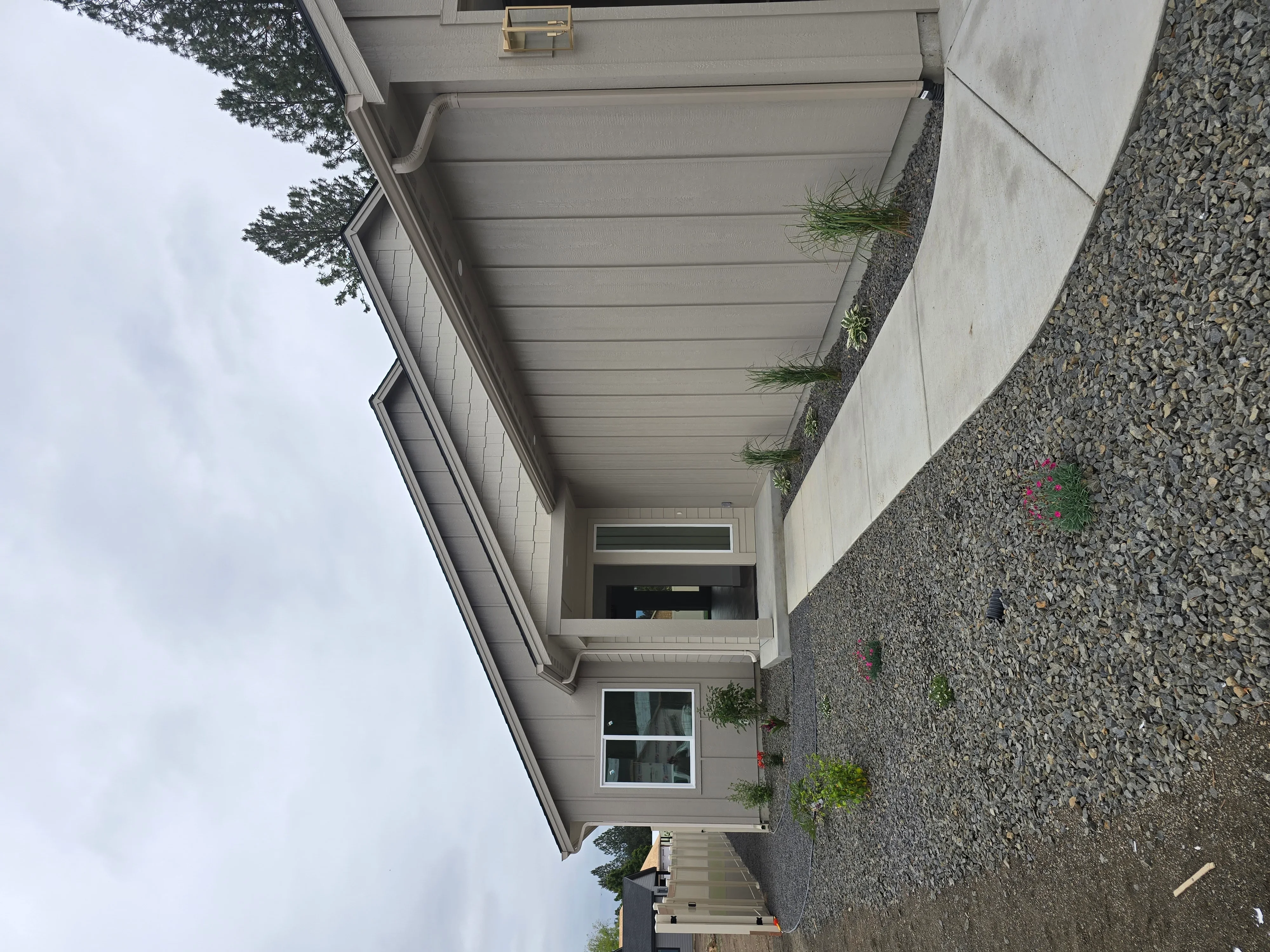 Horizontal vinyl soffit and fascia with integrated guttering on residential roofline